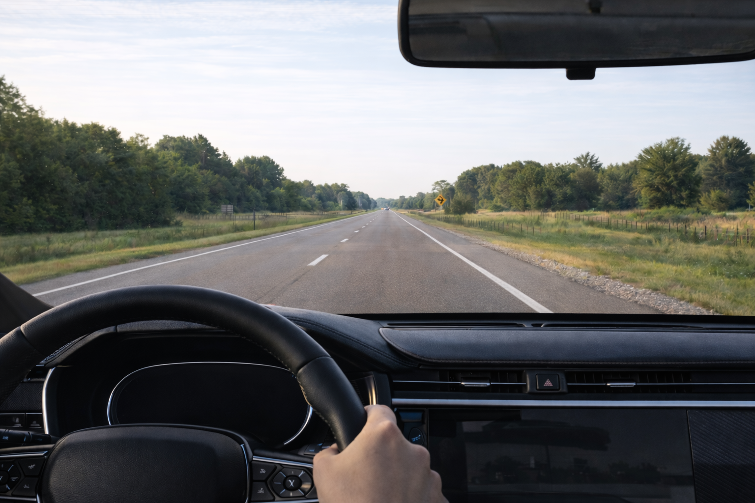 View from inside a car driving down an open road